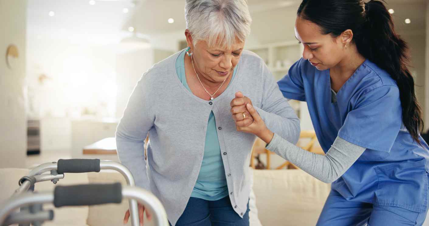 Senior woman being assisted in her home by a nurse