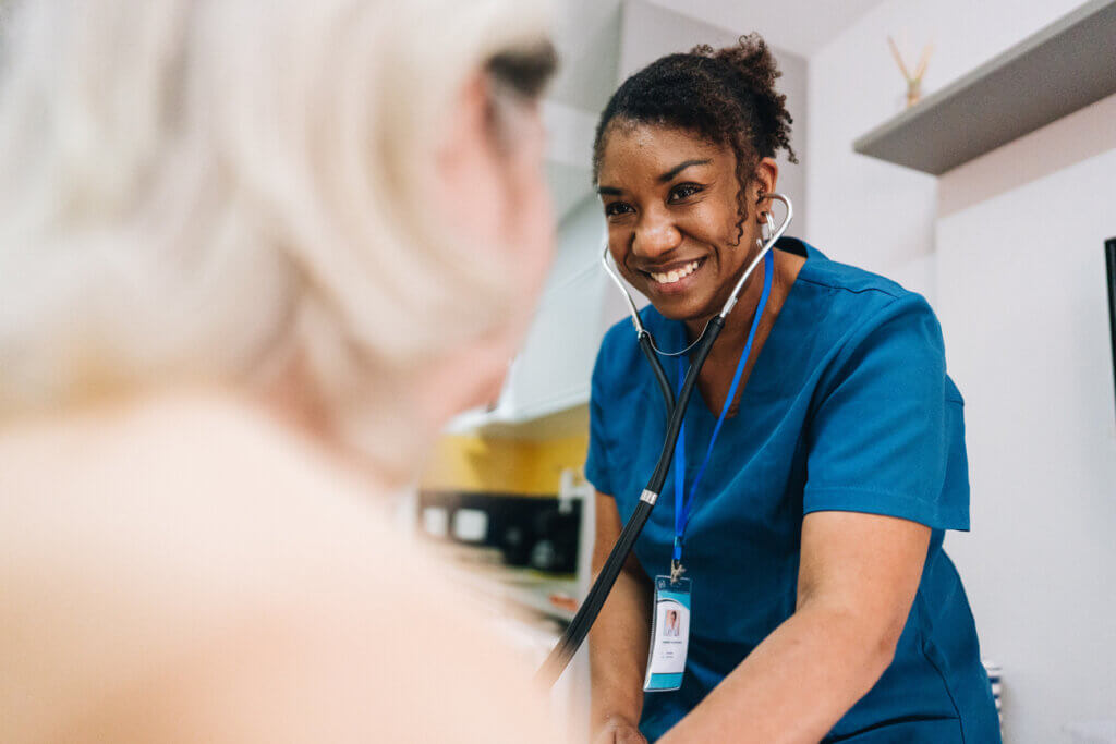 Nurse Taking Senior Patient's Blood Pressure